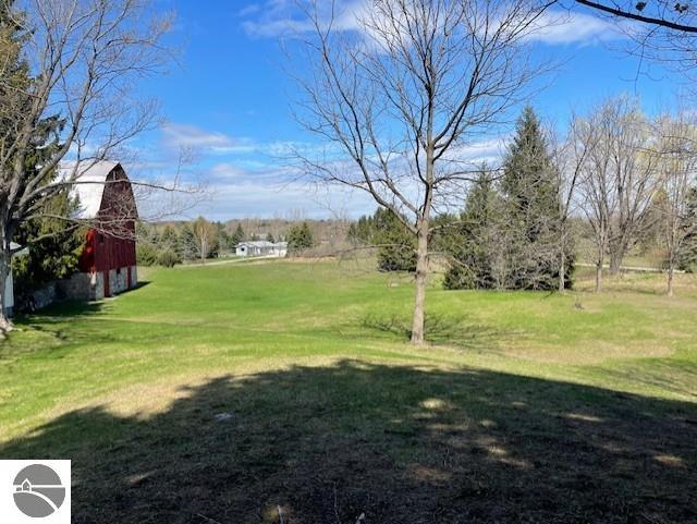 3312 Zimmerman Rd, Traverse City, MI 49685 - view of green lawn with a barn and an outbuilding