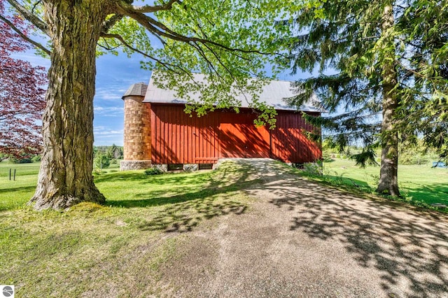 3312 Zimmerman Rd, Traverse City, MI 49685 - view of side of home with a lawn, an outbuilding, and a barn