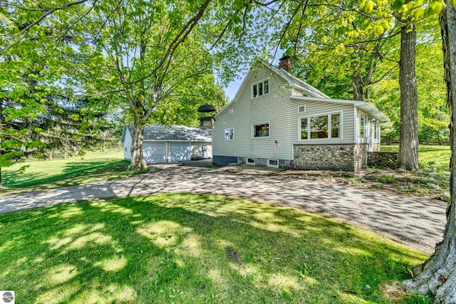 3312 Zimmerman Rd, Traverse City, MI 49685 - rear view of property with a chimney, a yard, and an outdoor structure
