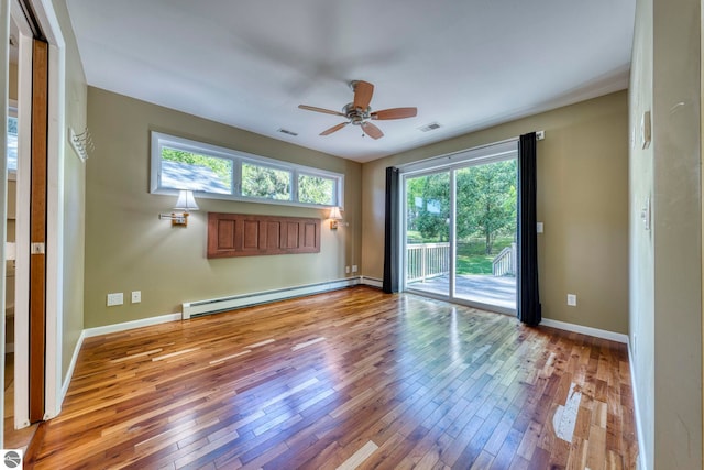 3312 Zimmerman Rd, Traverse City, MI 49685 - empty room with a baseboard radiator, hardwood / wood-style floors, a ceiling fan, and baseboards