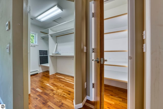 3312 Zimmerman Rd, Traverse City, MI 49685 - walk in closet with a baseboard heating unit and wood-type flooring