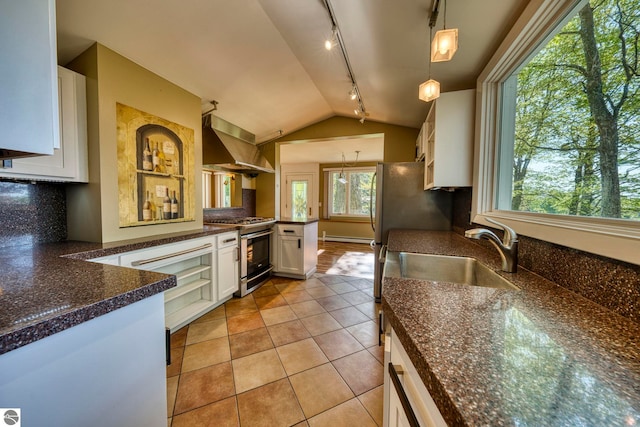 3312 Zimmerman Rd, Traverse City, MI 49685 - kitchen featuring stainless steel gas range, wall chimney exhaust hood, a sink, track lighting, and white cabinetry