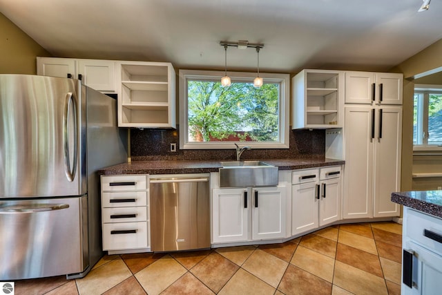 3312 Zimmerman Rd, Traverse City, MI 49685 - kitchen with appliances with stainless steel finishes, open shelves, a sink, tasteful backsplash, and white cabinetry