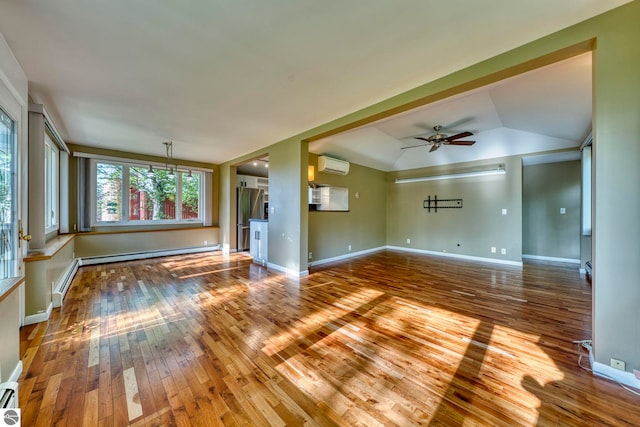 3312 Zimmerman Rd, Traverse City, MI 49685 - unfurnished living room featuring a wall unit AC, hardwood / wood-style flooring, a ceiling fan, baseboards, and vaulted ceiling