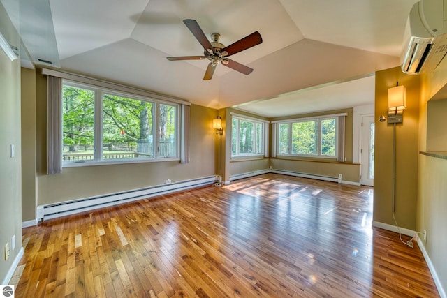 3312 Zimmerman Rd, Traverse City, MI 49685 - empty room with a baseboard radiator, a wall unit AC, hardwood / wood-style floors, lofted ceiling, and ceiling fan