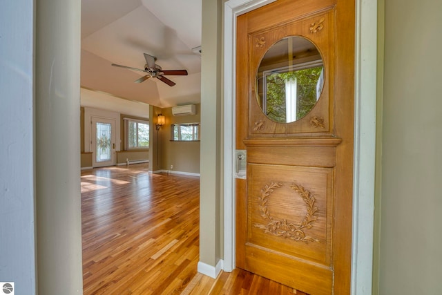 3312 Zimmerman Rd, Traverse City, MI 49685 - foyer with a wall mounted air conditioner, wood finished floors, a ceiling fan, baseboards, and lofted ceiling