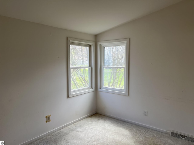carpeted spare room with baseboards