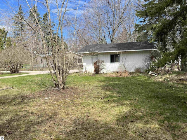 view of property exterior with a lawn