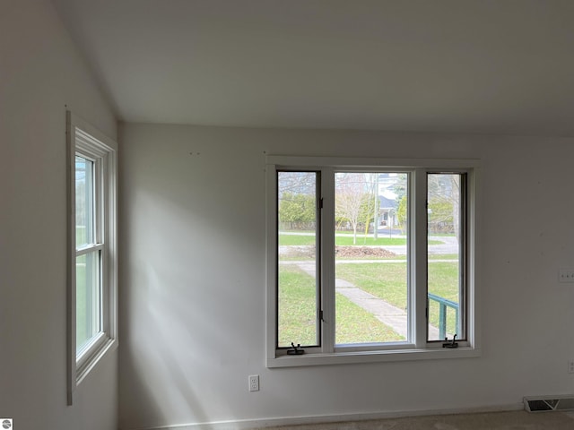 spare room featuring healthy amount of natural light and baseboards