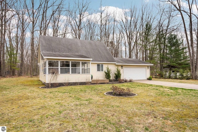 7555 Anthony St, Fife Lake, MI 49633 - view of front of home with a sunroom, a garage, driveway, and a front lawn