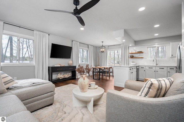 7555 Anthony St, Fife Lake, MI 49633 - living room featuring recessed lighting, wood finished floors, ceiling fan, and a chandelier