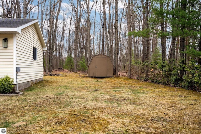 7555 Anthony St, Fife Lake, MI 49633 - view of green lawn with a storage shed and an outdoor structure