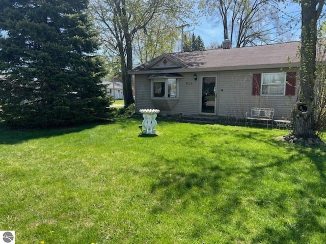 394 Wilson Ave, Mount Morris, MI 48458 - view of front facade featuring a front lawn and a chimney