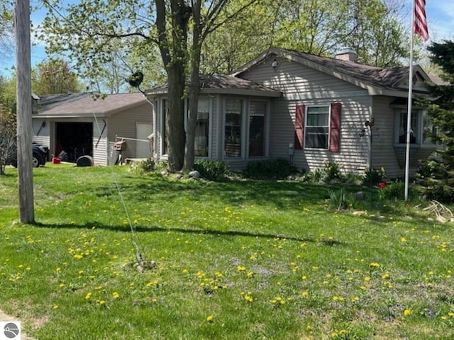 394 Wilson Ave, Mount Morris, MI 48458 - view of front of home with a garage, a front lawn, and a chimney