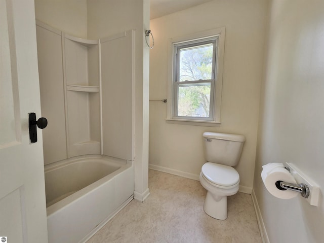 full bath with toilet, baseboards, and shower / bathtub combination