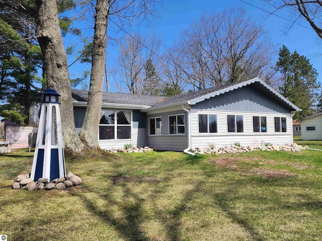 back of house with a yard and board and batten siding