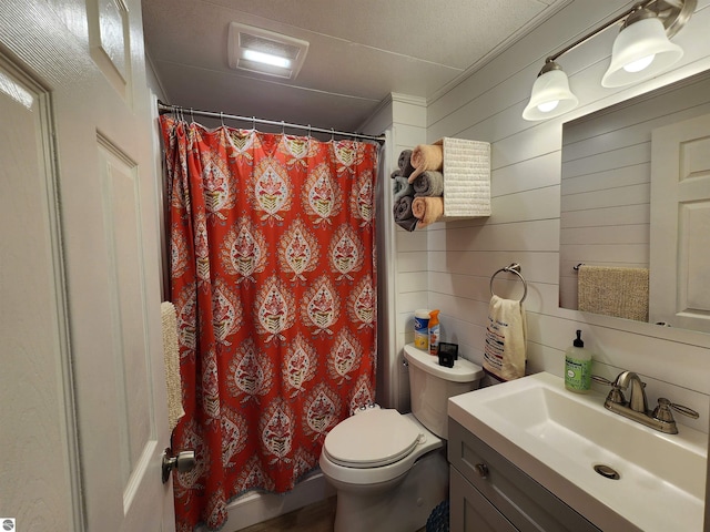 bathroom featuring toilet, vanity, a shower with curtain, and wooden walls