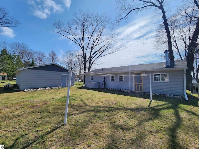 rear view of property with a lawn