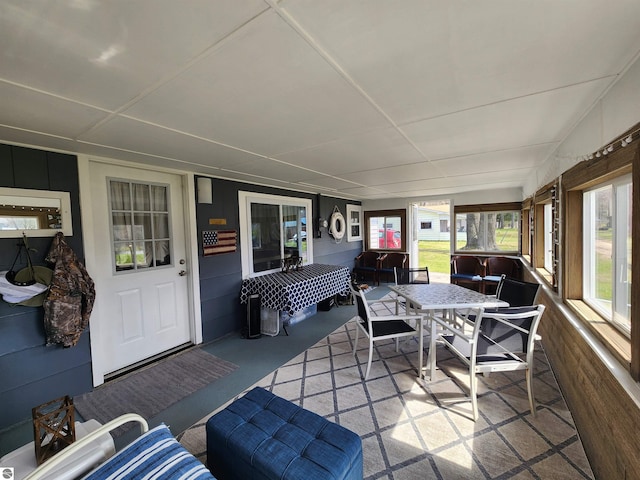 sunroom featuring outdoor dining space