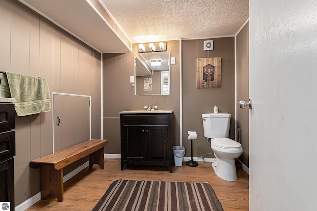 1956 S Goldenrod, Lake City, MI 49651 - bathroom with toilet, wood finished floors, and vanity
