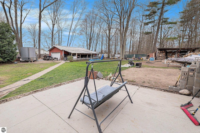 1956 S Goldenrod, Lake City, MI 49651 - view of patio featuring a garage and an outbuilding