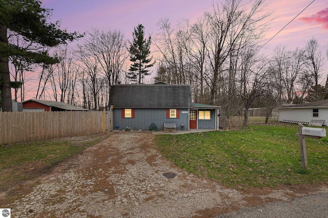 1956 S Goldenrod, Lake City, MI 49651 - view of front of house with dirt driveway and a shingled roof