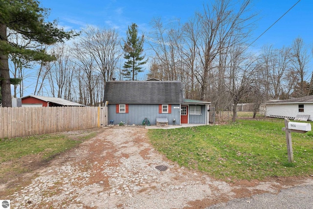 1956 S Goldenrod, Lake City, MI 49651 - colonial inspired home featuring a shingled roof and driveway