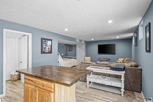 8565 Bent Pine Dr, Lake Ann, MI 49650 - living area with a textured ceiling, light wood finished floors, recessed lighting, and baseboards