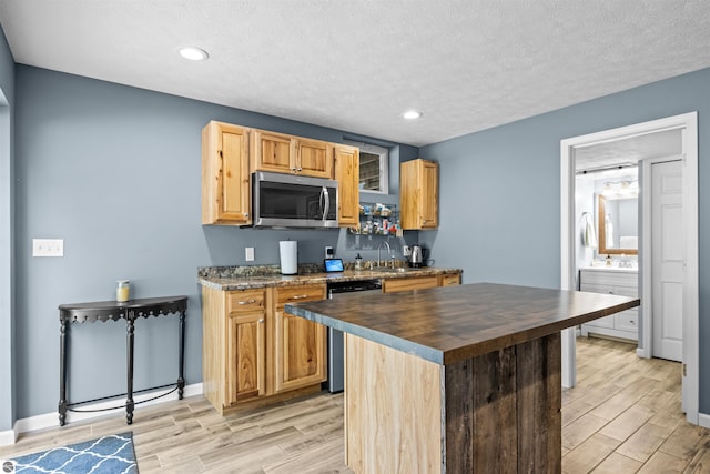 8565 Bent Pine Dr, Lake Ann, MI 49650 - kitchen featuring stainless steel appliances, butcher block counters, wood finish floors, a textured ceiling, and recessed lighting