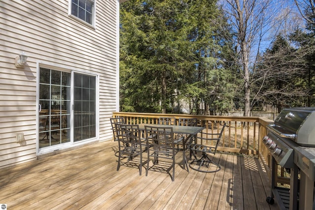8565 Bent Pine Dr, Lake Ann, MI 49650 - wooden deck featuring outdoor dining area and view of scattered trees