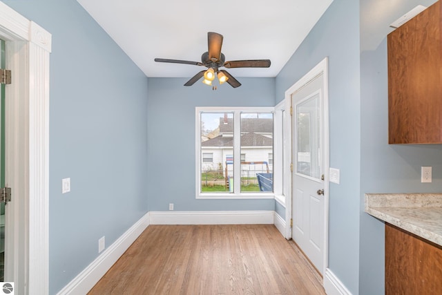 117 S Fancher St, Mount Pleasant, MI 48858 - unfurnished dining area featuring light wood-type flooring, baseboards, and ceiling fan