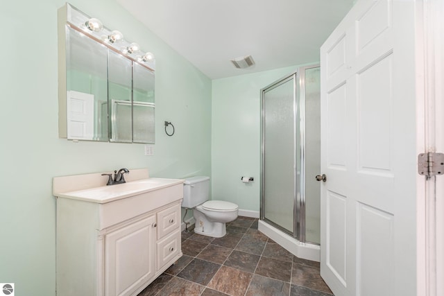 117 S Fancher St, Mount Pleasant, MI 48858 - full bath with a stall shower, vanity, toilet, stone finish floors, and baseboards