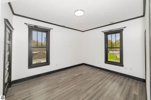 117 S Fancher St, Mount Pleasant, MI 48858 - empty room with crown molding, wood finished floors, and baseboards