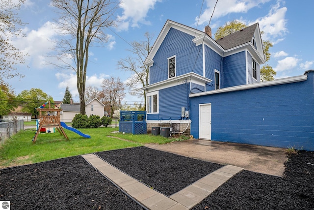 117 S Fancher St, Mount Pleasant, MI 48858 - rear view of property with a playground, a chimney, and central AC unit
