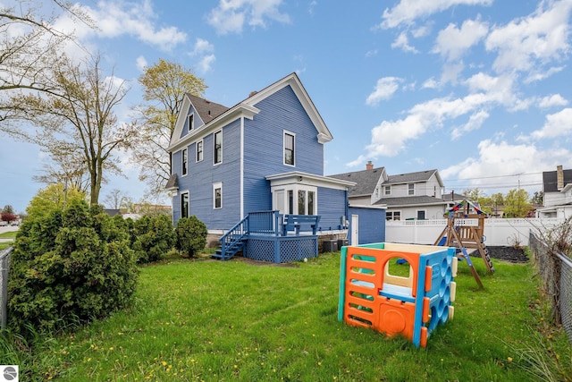117 S Fancher St, Mount Pleasant, MI 48858 - back of property featuring a deck, a playground, and cooling unit