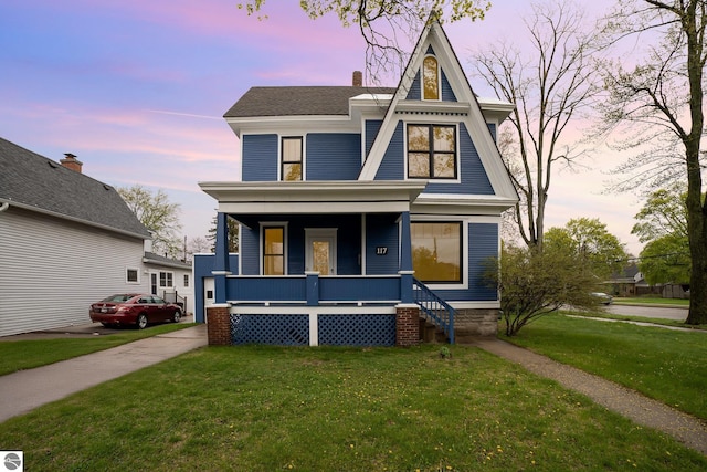117 S Fancher St, Mount Pleasant, MI 48858 - view of front of home with covered porch, a front lawn, and a chimney