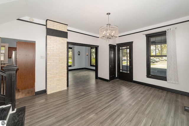 117 S Fancher St, Mount Pleasant, MI 48858 - unfurnished dining area with a chandelier, wood finished floors, and baseboards