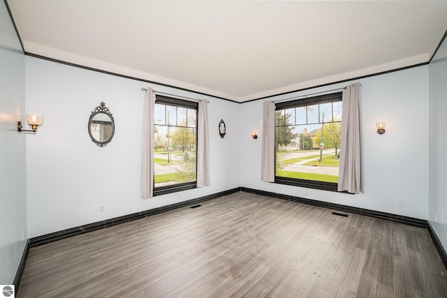 117 S Fancher St, Mount Pleasant, MI 48858 - unfurnished room with wood finished floors and baseboards