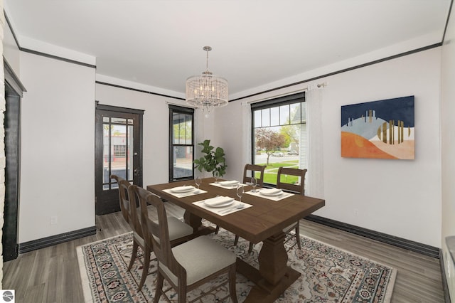 117 S Fancher St, Mount Pleasant, MI 48858 - dining room featuring a chandelier, light wood-type flooring, and baseboards