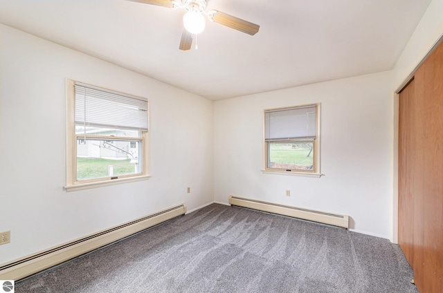 4120 M-66, Kalkaska, MI 49646 - unfurnished bedroom featuring a baseboard radiator, multiple windows, and carpet
