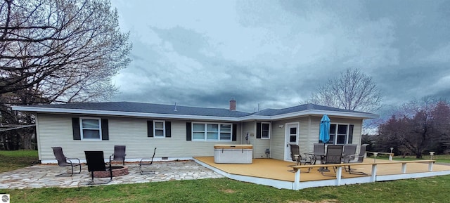 4120 M-66, Kalkaska, MI 49646 - rear view of house featuring a wooden deck, a patio, a chimney, a lawn, and crawl space