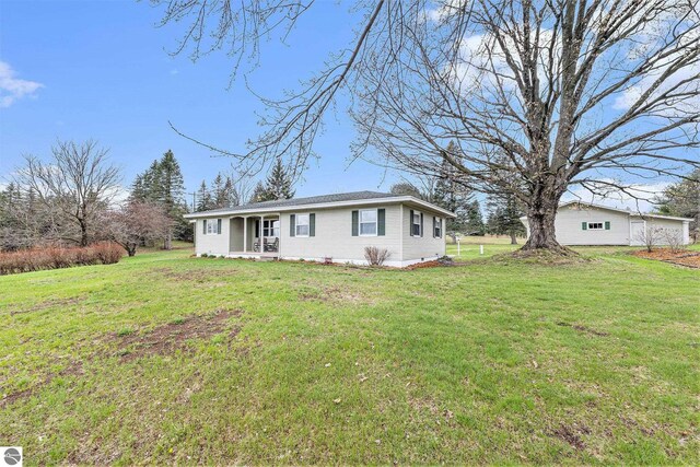 4120 M-66, Kalkaska, MI 49646 - ranch-style home with a front lawn and a porch