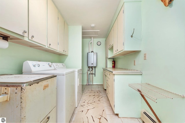 4120 M-66, Kalkaska, MI 49646 - washroom featuring washer and dryer, tankless water heater, cabinet space, light tile patterned floors, and a baseboard radiator