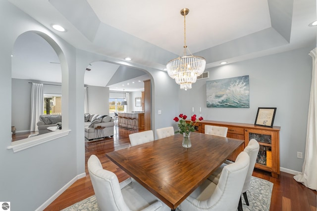726 Doe Trl, Mount Pleasant, MI 48858 - dining space featuring arched walkways, a chandelier, dark wood-style flooring, recessed lighting, and baseboards