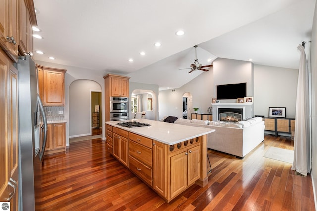 726 Doe Trl, Mount Pleasant, MI 48858 - kitchen featuring arched walkways, ceiling fan, appliances with stainless steel finishes, open floor plan, and light countertops