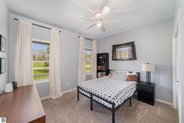 726 Doe Trl, Mount Pleasant, MI 48858 - carpeted bedroom featuring baseboards and a ceiling fan