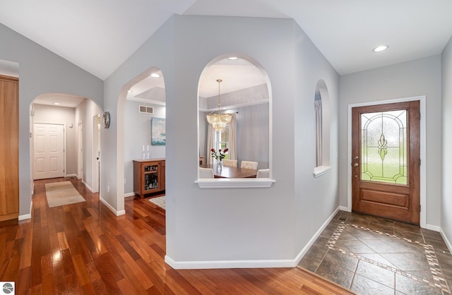 726 Doe Trl, Mount Pleasant, MI 48858 - entrance foyer with healthy amount of natural light, baseboards, lofted ceiling, recessed lighting, and arched walkways
