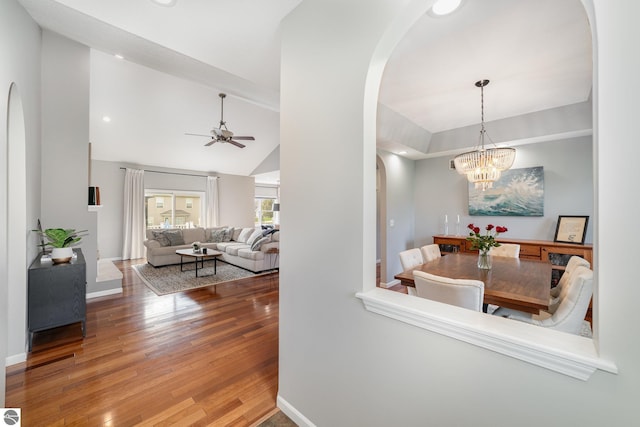 726 Doe Trl, Mount Pleasant, MI 48858 - hallway with arched walkways, wood finished floors, lofted ceiling, a chandelier, and baseboards