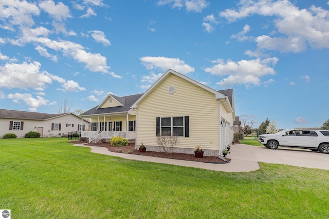 726 Doe Trl, Mount Pleasant, MI 48858 - back of house with covered porch, driveway, and a lawn