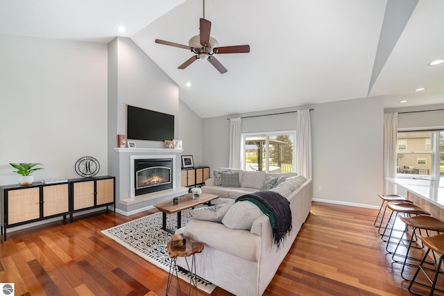 726 Doe Trl, Mount Pleasant, MI 48858 - living area with a glass covered fireplace, ceiling fan, wood finished floors, recessed lighting, and high vaulted ceiling